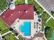 Overhead shot of a community pool area featuring lounge seating, tables, and a clubhouse, ideal for outdoor fun at 7413 Surrey Wood Ln, Apollo Beach, FL 33572