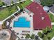 A stunning high angle view of a rectangular community pool surrounded by palm trees and lounge chairs at 7413 Surrey Wood Ln, Apollo Beach, FL 33572