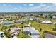 An aerial view shows the home nestled in a friendly neighborhood with well-maintained landscaping and nearby amenities at 7504 Carissa, Punta Gorda, FL 33955