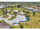 An aerial view of the home and surrounding neighborhood showcasing a tranquil residential community with beautiful landscaping at 7504 Carissa, Punta Gorda, FL 33955