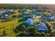 Aerial view of a home with a screened lanai and well-kept landscaping in a quiet neighborhood at 7504 Carissa, Punta Gorda, FL 33955