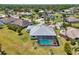 An aerial view features the home's screened pool, manicured backyard, and its location in a quiet residential neighborhood at 7504 Carissa, Punta Gorda, FL 33955
