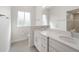Bright bathroom featuring double sinks, white cabinets, and a walk-in shower at 7504 Carissa, Punta Gorda, FL 33955