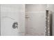 Stylish bathroom shower featuring elegant marble tiles and a sleek shower head fixture at 7504 Carissa, Punta Gorda, FL 33955