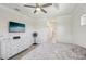 Bright bedroom featuring a ceiling fan, dresser, and view to the en-suite bathroom at 7504 Carissa, Punta Gorda, FL 33955