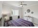 Cozy bedroom features a decorative ceiling fan, comfortable bed, and stylish decor at 7504 Carissa, Punta Gorda, FL 33955