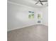 Bright bedroom featuring a ceiling fan, tile floors, and a glass door that leads to the backyard at 7504 Carissa, Punta Gorda, FL 33955