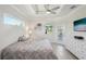 Cozy bedroom featuring a ceiling fan, a TV, and access to outdoor patio through a glass door at 7504 Carissa, Punta Gorda, FL 33955