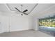 Spacious bedroom with tile floors and sliding glass doors to a screened lanai and pool at 7504 Carissa, Punta Gorda, FL 33955