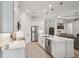 Spacious kitchen featuring stainless steel appliances, white cabinets, and a center island at 7504 Carissa, Punta Gorda, FL 33955