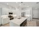 Bright kitchen featuring a center island, stainless steel appliances, and white cabinets at 7504 Carissa, Punta Gorda, FL 33955