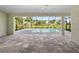 Spacious patio area with gray pavers overlooking a private pool and a lush backyard at 7504 Carissa, Punta Gorda, FL 33955