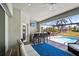 Enclosed patio with a built-in bar, comfortable seating, and a view of the pool at 7504 Carissa, Punta Gorda, FL 33955