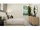 Bright bedroom featuring a modern dresser, neutral bedding, and a large window with natural light at 7533 E 116Th St, Palmetto, FL 34221