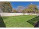Lush green backyard with a well-maintained lawn, complemented by a tall privacy fence and mature trees at 7725 Bingham Ct, Tampa, FL 33625