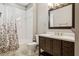 Bathroom with a shower, tub, and a dark wood vanity cabinet at 7725 Bingham Ct, Tampa, FL 33625