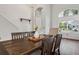Light-filled dining room showcasing a wood table, comfortable seating, and an open view to the front entrance at 7725 Bingham Ct, Tampa, FL 33625