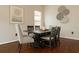 Elegant dining room featuring a dark wood table, upholstered chairs, and modern wall art at 7725 Bingham Ct, Tampa, FL 33625