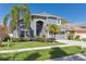Charming two-story home boasting lush landscaping, a well-manicured lawn, and a classic gray exterior at 7725 Bingham Ct, Tampa, FL 33625