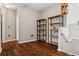 Hallway with hardwood flooring, shelving, and neutral color scheme at 7725 Bingham Ct, Tampa, FL 33625