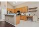 Well-lit kitchen featuring stainless steel appliances, wood cabinets, and tiled floors for a modern touch at 7725 Bingham Ct, Tampa, FL 33625