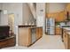 Spacious open kitchen featuring stainless steel appliances, wood cabinets, and a convenient breakfast bar at 7725 Bingham Ct, Tampa, FL 33625