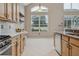 Bright and airy kitchen with modern appliances, light wood cabinetry, and ample counter space at 7725 Bingham Ct, Tampa, FL 33625
