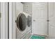 Bright laundry room with modern washer and dryer and tiled flooring at 7725 Bingham Ct, Tampa, FL 33625