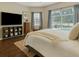 Comfortable main bedroom featuring a large window overlooking the pool and natural light at 7725 Bingham Ct, Tampa, FL 33625