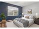 Comfortable main bedroom with a large window and blue accent wall at 7725 Bingham Ct, Tampa, FL 33625