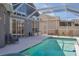 Enclosed pool with a large deck, outdoor furniture and attached hot tub at 7725 Bingham Ct, Tampa, FL 33625