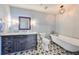 Charming bathroom with a classic clawfoot tub, unique patterned floor, and stylish vanity at 777 N Ashley Dr # 3002, Tampa, FL 33602