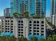 Exterior view of parking garage with palm trees and blue accents at 777 N Ashley Dr # 3002, Tampa, FL 33602