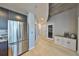 Modern kitchen featuring stainless steel refrigerator, gray cabinetry, and light hardwood flooring throughout at 777 N Ashley Dr # 3002, Tampa, FL 33602