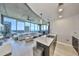 Open-concept living room with floor-to-ceiling windows and modern kitchen with marble counters at 777 N Ashley Dr # 3002, Tampa, FL 33602