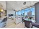 Open-concept living space with city views, sleek bar stools, a modern light fixture, and comfortable seating at 777 N Ashley Dr # 3002, Tampa, FL 33602