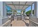 Outdoor kitchen and bar area with overhead shade structure and beautiful pool view at 777 N Ashley Dr # 3002, Tampa, FL 33602