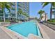 Enjoy this outdoor pool with a view of the condo building and clear blue skies at 777 N Ashley Dr # 3002, Tampa, FL 33602