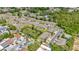 Townhome community featuring tree-lined streets, lush greenery, a serene pond, and a community pool at 8013 Savannah Sunset Ln, Tampa, FL 33615