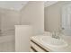 Bathroom with sink, mirror, and shower/tub at 8013 Savannah Sunset Ln, Tampa, FL 33615
