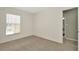 Bright bedroom with carpet floors, large window, and neutral wall paint at 8013 Savannah Sunset Ln, Tampa, FL 33615