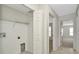 Hallway with washer/dryer hookups and carpeted bedrooms on display at 8013 Savannah Sunset Ln, Tampa, FL 33615