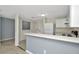 Open kitchen area featuring white cabinets and appliances with a breakfast bar at 8013 Savannah Sunset Ln, Tampa, FL 33615