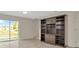 Living Room featuring a built-in bookshelf and sliding glass doors providing natural light at 8013 Savannah Sunset Ln, Tampa, FL 33615