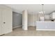 Open concept living room and kitchen with white appliances and tile flooring at 8013 Savannah Sunset Ln, Tampa, FL 33615
