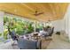 Spacious covered patio featuring a wood ceiling, tile floors, and multiple seating areas at 807 W Braddock St, Tampa, FL 33603