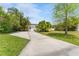 Property featuring a spacious concrete driveway, lush greenery, and a charming single-story home at 807 W Braddock St, Tampa, FL 33603