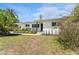Well-maintained single-story home with manicured landscaping, a secure fence, and fresh white paint at 807 W Braddock St, Tampa, FL 33603
