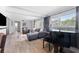 Bright living room featuring wood floors, large window, piano, and comfortable seating at 807 W Braddock St, Tampa, FL 33603