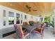 Outdoor dining space with elegant furniture, ceiling fans, and a cozy ambiance for entertaining at 807 W Braddock St, Tampa, FL 33603